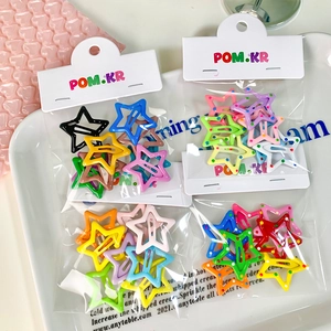 Colorful star-shaped hair clips set with polka dots on a bright decorative tray