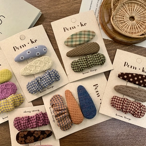 Chic Korean style fabric checkered and knitted hair clips set for women on display