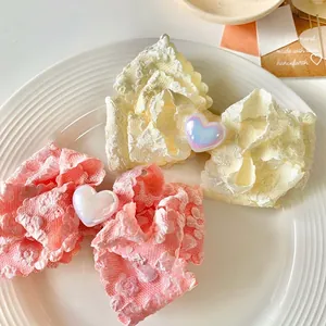 Fermagli per capelli a fiocco in pizzo rosa e beige con perla a cuore in vassoio