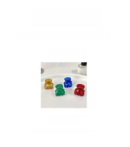 Set of four mini colorful pumpkin hair claws in blue, amber, green, and red colors