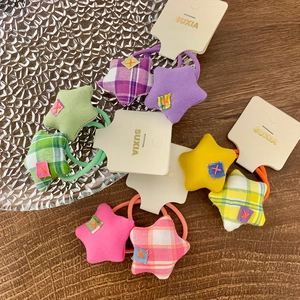Plaid and striped fabric scrunchies set with star detail in assorted vibrant colors