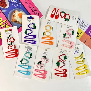 Colorful fruit shaped hair clips set with strawberry and pineapple designs on display cards