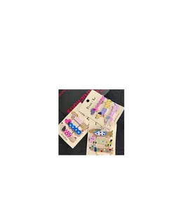 Detailed view of colorful dachshund hair clips with polka dots and dimensions 7x2cm