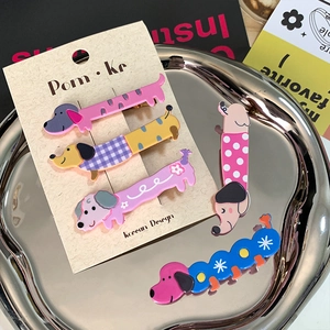 Set of 5 colorful cartoon dog and caterpillar hair clips for girls in a silver tray