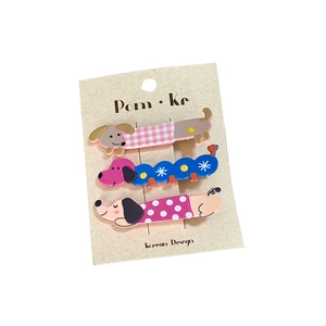Three-piece colorful dachshund dog hair clips with plaid and polka dot patterns on card