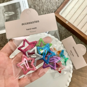 Glitter star hair clips set in vibrant colors for girls on a stylish accessory card