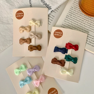 Colorful mini bow hair clips set made of grosgrain ribbon displayed on cards