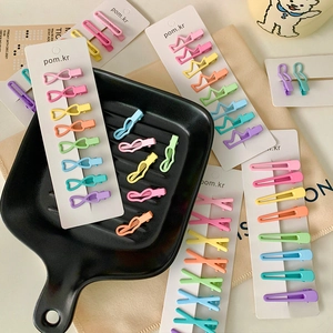 Colorful macaron metal hair clips set with crown and bow shapes on display card