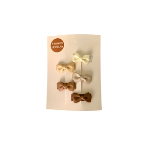 Set of 5 minimalist macaron bow hair clips in earthy colors on a white display card