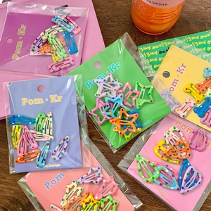 Candy colored polka dot hair clips set with star and heart shapes on card board