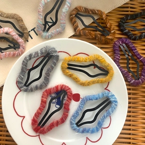 Handmade knitted wool cloud hair clip set in various colors on a rustic tray