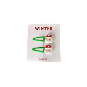 Cute Santa Claus themed hair clips set with green metal base on white packaging card