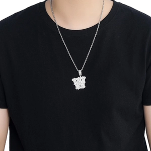 Détail macro du pendentif lettre W serti de zircons sur une chaîne torsadée argent