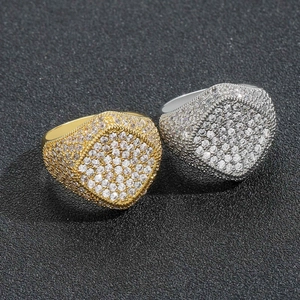 Detailed macro view of gold and silver hip hop signet rings with pave cubic zirconia