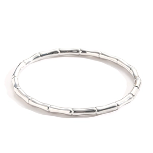 Minimalist silver bamboo-shaped metal bangle with a high-polished finish on white background