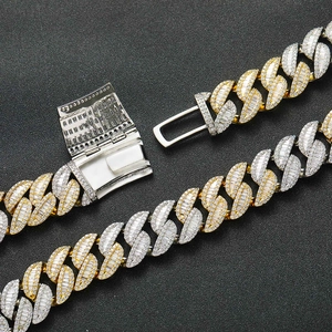 Detailed macro view of 20mm two-tone Cuban link chain with baguette and round cut diamonds