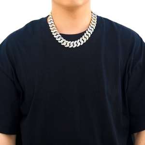 Close-up of 20mm hip-hop Cuban link chain with T-shaped cubic zirconia on male model