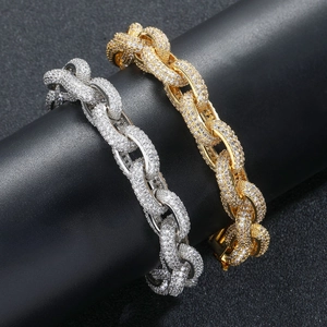 Macro view of gold and silver thick chain bracelets with paved cubic zirconia stones