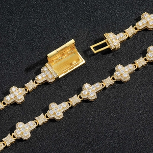 Detailed close-up of 10mm gold cross link bracelet with shimmering zircon pavé stones