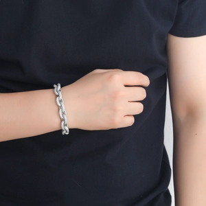 Macro shot of 12mm silver hip hop chain bracelet with micro-paved white zircons on wrist