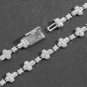 Macro view of iced out 10mm cross clover bracelet with zircon stones and box clasp closure