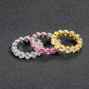 Three hip hop heart shaped zircon eternity rings in silver and gold finishes