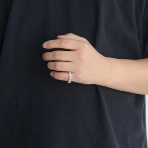 Detail of silver eternity band with continuous heart-cut cubic zirconia stones