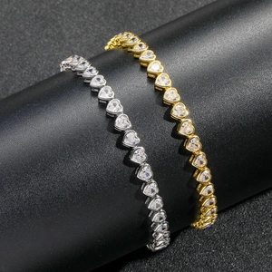 Coppia di bracciali tennis a cuore da 5mm in argento e oro su un espositore per gioielli