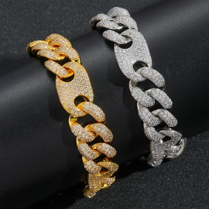 Macro detail of gold and silver iced out Cuban links with handset cubic zirconia