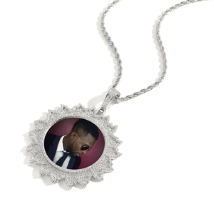 Macro view of silver custom photo pendant with sunburst frame and cubic zirconia stones
