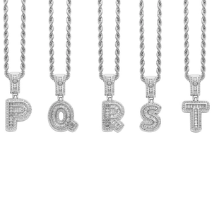 Detail view of iced-out P Q R S T letter pendants with cubic zirconia and rope chain