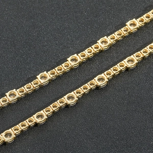 Close-up of gold tennis chain showing round bezel-set cubic zirconia and fine craftsmanship