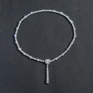 Detail of silver tennis necklace featuring a Y-shaped heart pendant and micro-set cubic zirconia