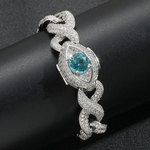 Détail d'une chaîne cubaine 16mm sertie de zircons avec un œil bleu central de luxe