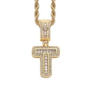 Close-up of hip hop golden T-shaped letter pendant with zircon stones and rope chain