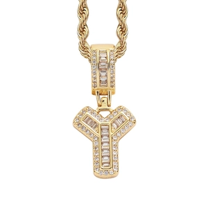 Detailed macro view of iced-out gold letter Y pendant with cubic zirconia on a rope chain