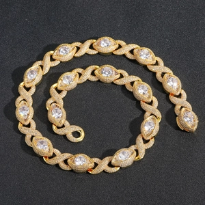 Golden XO link hip hop necklace with micro-paved zircons on a dark background