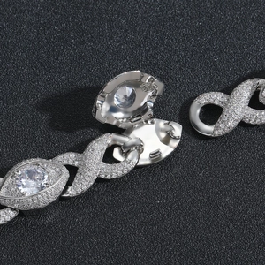 Macro shot of silver hip-hop chain buckle with micro-paved zircons and 8-shape links
