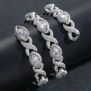 Macro detail of 15mm cuban link chain with marquise cut zircon and infinity design