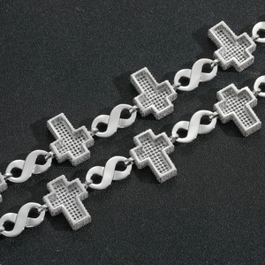 Close-up of hip-hop cross necklace with pavé zircon stones and infinity symbols