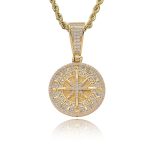 Iced out compass pendant with white zircons and golden twist chain on white background