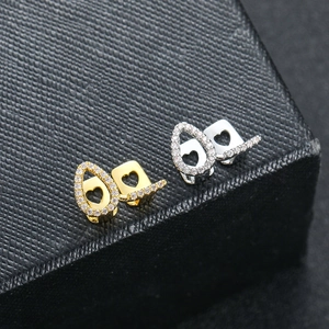Macro shot of gold and silver heart-shaped grillz with cubic zirconia inlays