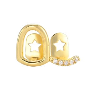 Macro view of gold hip-hop teeth grills featuring star cutouts and paved zircons