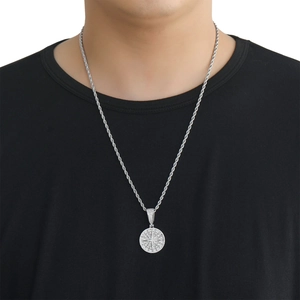 Detailed view of hip hop compass pendant with white zircons on silver rope chain