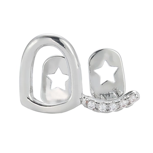 Detail of silver hip hop grillz with sparkling zircons and star-cut metal design