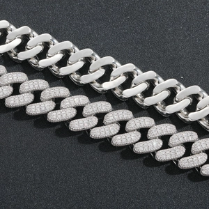 Detail of 20mm hip hop Cuban link chain featuring polished silver and pavé zircon stones