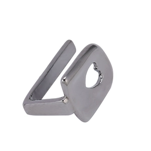 Detailed view of silver metal open ring featuring a square plate with a hollow heart cutout