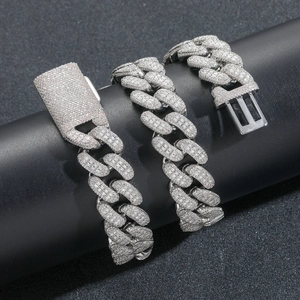 Macro detail of 20mm silver Cuban link chain with pave set baguette zircon stones