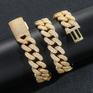 Macro shot of 20mm gold Cuban chain with heavy zircon stones and box clasp details