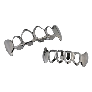 Macro shot of hollow hip hop fangs in gun black metal finish for Halloween costume